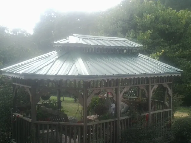 Two tier green metal roof on a garden gazebo in Lakeville