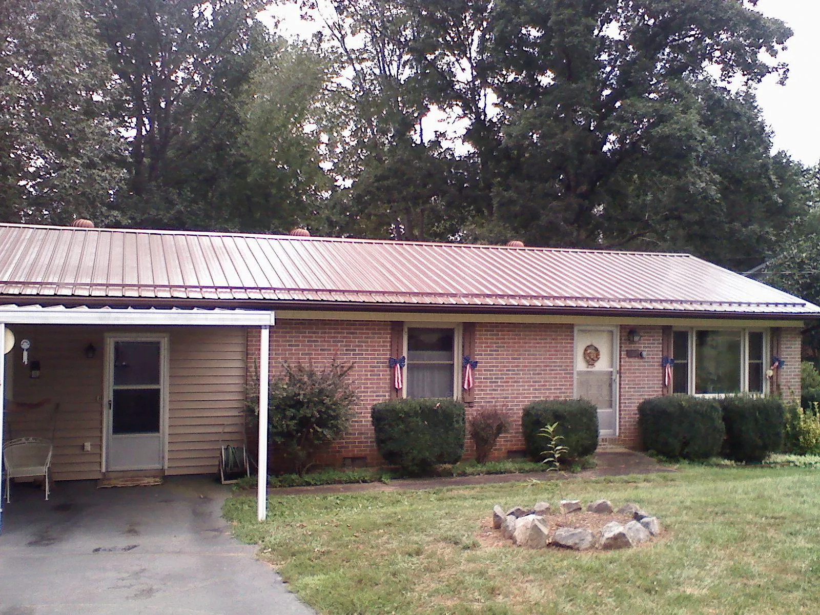 Bronze metal roof and carport on a brick ranch home — Roof Repair work by our crew in Lakeville
